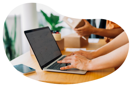 A retailer applying for insurance quotes on a laptop. A retailer applying for insurance quotes on a laptop.