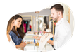 Jewelry store employee helping a customer try on rings.