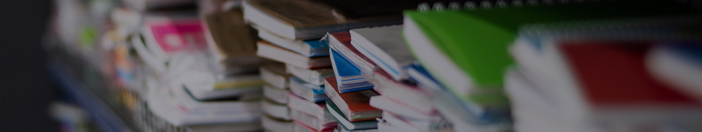 Notebooks on display at an office supply store.