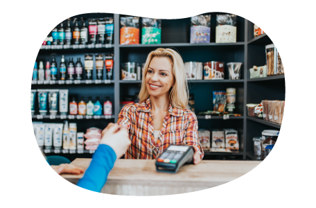 Pet supply store cashier checking out a customer at a counter.