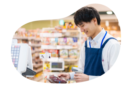 A cashier at a pharmacy rings up an order at a counter.
