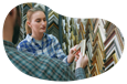 A salesperson shows a customer a frame sample.