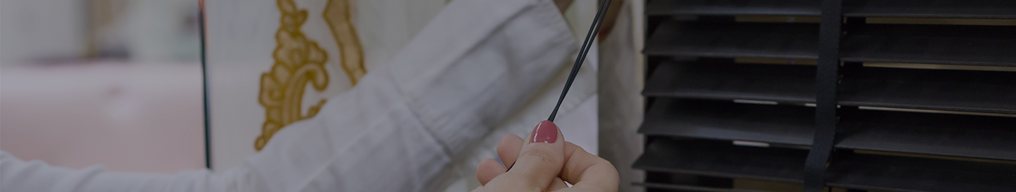 A customer measures their window blinds.