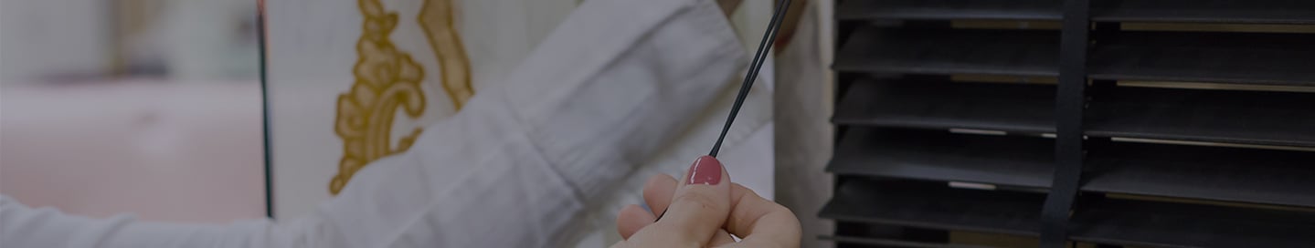 A customer measures their window blinds. A customer measures their window blinds.