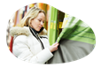 A customer examines curtains in a window shade and curtain store.