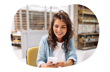 A Shopify seller responds to a customer's message on their smartphone.