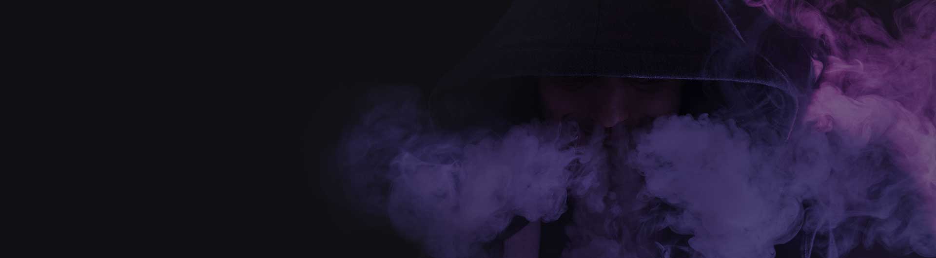 Young man on a dark background holding an electronic cigarette, vaping device. Young man on a dark background holding an electronic cigarette, vaping device.