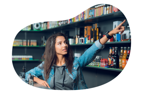 Tobacco shop employee helping a customer find a product on a shelf. Tobacco shop employee helping a customer find a product on a shelf.