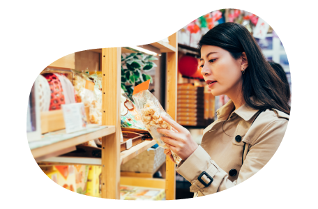A shopper picks up a bag of popcorn in a specialty food store.