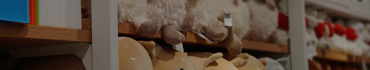 Stuffed animals on a shelf in a toy store.