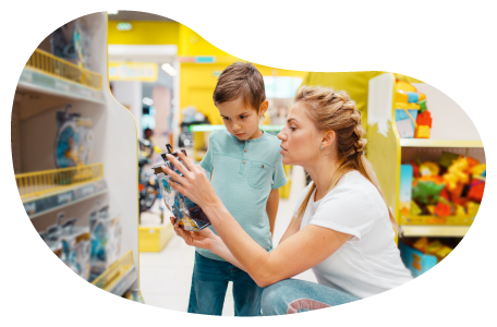 A mother and her child examine a toy in a toy store.