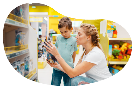 A mother and her child examine a toy in a toy store. A mother and her child examine a toy in a toy store.