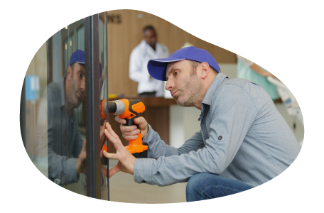 A vending machine operator working on a machine. A vending machine operator working on a machine.