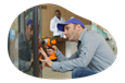 A vending machine operator working on a machine.