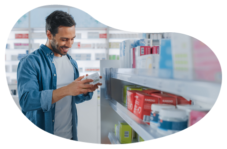 A shopper examines a product in a vitamin store.