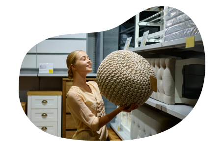 A Wayfair seller looks at a pouf ottoman in their warehouse. A Wayfair seller looks at a pouf ottoman in their warehouse.