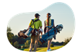 Two golfers carry their gear across a golf course.