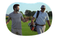 A golf instructor and their student walk across a golf course.