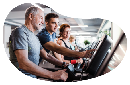 Fitness center employee helping a client on a treadmill. Fitness center employee helping a client on a treadmill.