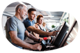 Fitness center employee helping a client on a treadmill.