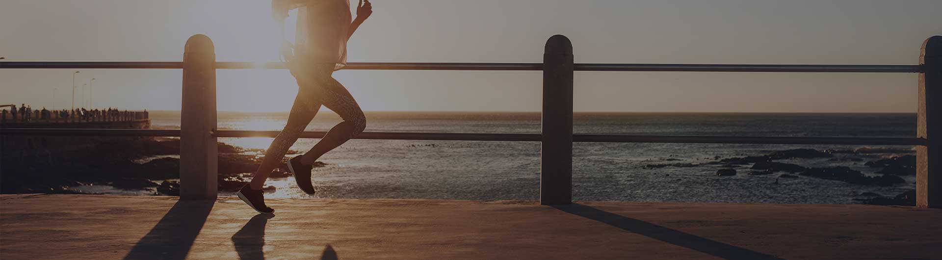 Person running alongside the ocean.