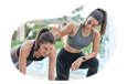 Personal trainer helping a client in a fitness center.