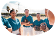 Members of a softball sports club gather on a field.
