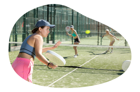 Members of a tennis club playing a doubles match. Members of a tennis club playing a doubles match.