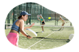 Members of a tennis club playing a doubles match.