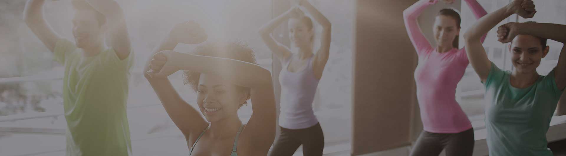 Several people working out in a Zumba class. Several people working out in a Zumba class.