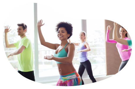 Zumba instructor guiding a class through a routine in a studio. Zumba instructor guiding a class through a routine in a studio.