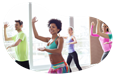 Zumba instructor guiding a class through a routine in a studio.