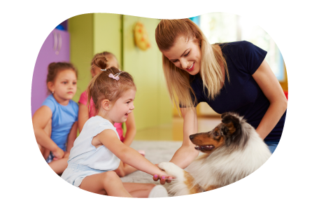 Animal assisted therapist introducing a dog to a group of children. Animal assisted therapist introducing a dog to a group of children.