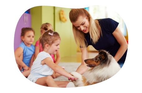 Animal assisted therapist introducing a dog to a group of children.