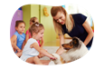 Animal assisted therapist introducing a dog to a group of children.