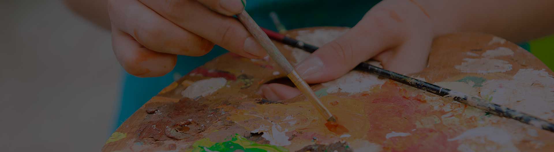 Young girl draws a picture paints on art therapy session.