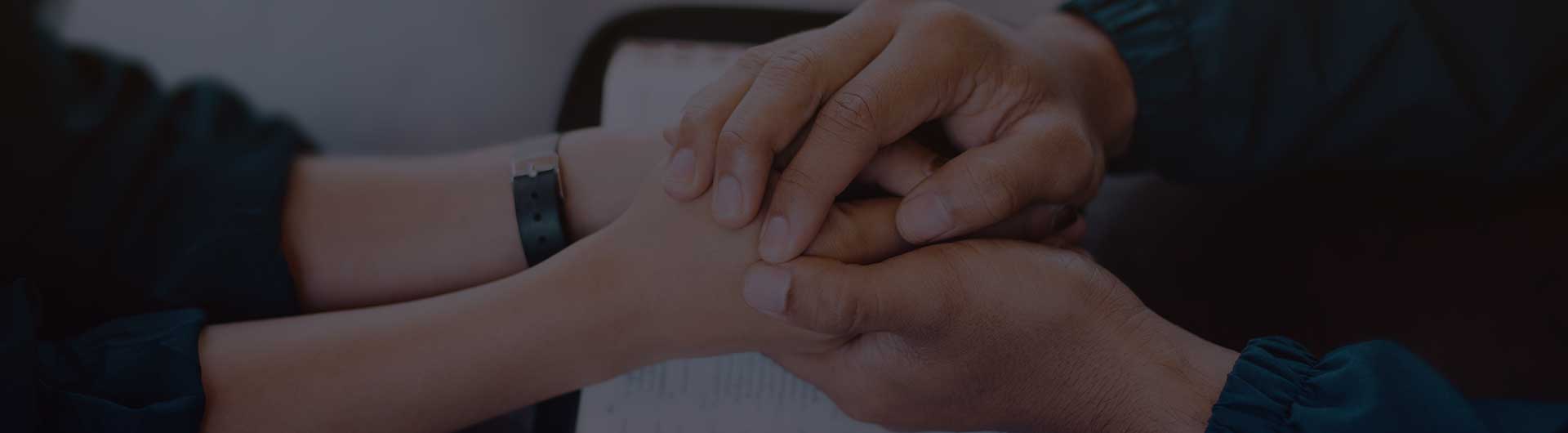Holding hands together and prayer on holy bible.