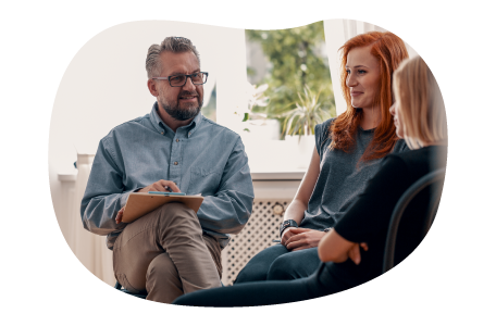Faith-based counselor speaking with a group of people in a room. Faith-based counselor speaking with a group of people in a room.