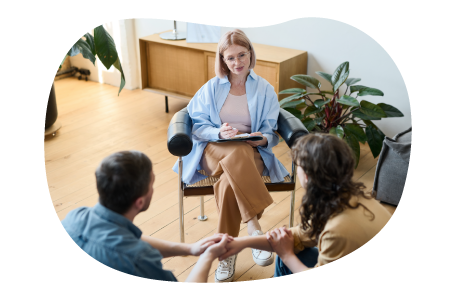 Marriage therapist counseling a couple in an office. Marriage therapist counseling a couple in an office.