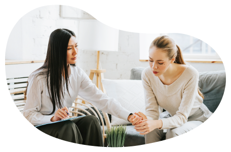 Mental health counselor supporting a patient in an office.