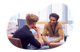 School counselor speaking with a student in their office.