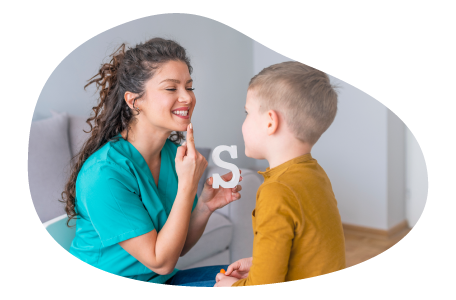 Speech therapist helping a child sound out words in their office.