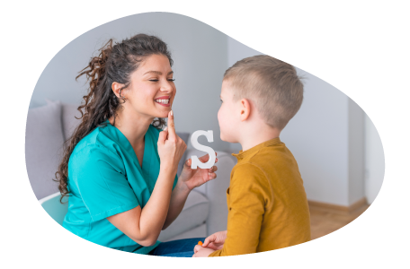 Speech therapist helping a child sound out words in their office.