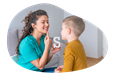 Speech therapist helping a child sound out words in their office.