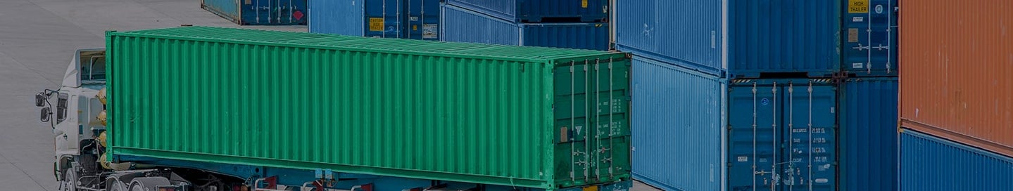 A truck with a cargo trailer at a shipping container yard. A truck with a cargo trailer at a shipping container yard.