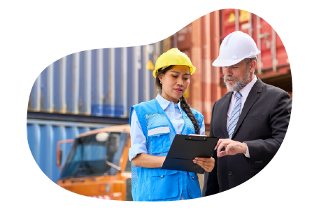 A business owner speaks with an employee at a container yard.