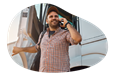 The owner of a motor carrier company talking on the phone with a client.