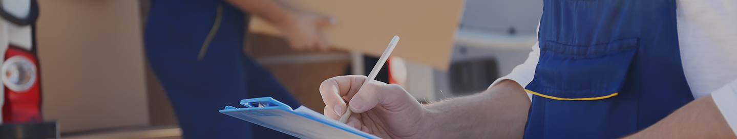 Moving company owner filling out a checklist.