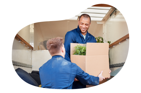 Two professional movers carrying boxes. Two professional movers carrying boxes.