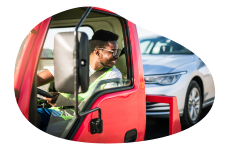 Tow truck driver hauling a client car.
